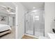This bathroom offers a walk-in shower with glass doors and gray tile, across from a bedroom at 308 Golan Circle # A, Myrtle Beach, SC 29579
