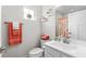 Cozy bathroom featuring toilet, sink with mirror, and window providing natural light at 308 Golan Circle # A, Myrtle Beach, SC 29579