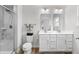 Bright bathroom featuring double vanity, framed mirrors, and tiled walk-in shower with glass door at 308 Golan Circle # A, Myrtle Beach, SC 29579