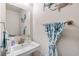 Powder room featuring a stylish pedestal sink, brushed nickel fixtures, and coastal-themed decor for a refreshing aesthetic at 308 Golan Circle # A, Myrtle Beach, SC 29579