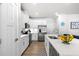 A contemporary kitchen boasts white cabinets, stainless steel appliances, quartz countertops, and a convenient center island at 308 Golan Circle # A, Myrtle Beach, SC 29579