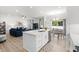 A kitchen island overlooks a living area with hardwood floors and a breakfast nook, creating an open and inviting living space at 308 Golan Circle # A, Myrtle Beach, SC 29579
