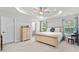 A light-filled main bedroom features a tray ceiling, carpet flooring, ensuite bathroom, and a calming, neutral color scheme at 308 Golan Circle # A, Myrtle Beach, SC 29579