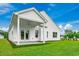 Spacious backyard featuring a covered patio and lush green lawn, perfect for outdoor entertaining at 308 Mayflower Dr., Calabash, NC 28467