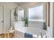 Relaxing bathroom showcasing a soaking tub, a separate glass-enclosed shower, and a frosted window at 308 Mayflower Dr., Calabash, NC 28467