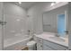 Bright bathroom with a tub, white cabinets, and a single sink at 308 Mayflower Dr., Calabash, NC 28467