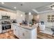 Stylish kitchen featuring a granite island with pendant lighting that opens into a living area at 308 Mayflower Dr., Calabash, NC 28467