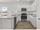 Bright kitchen featuring white cabinets, stainless steel appliances, and granite countertops at 308 Mayflower Dr., Calabash, NC 28467