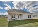 Backyard patio area for entertaining, with chairs, a fire pit, and a grassy yard at 312 Mayflower Dr., Calabash, NC 28467