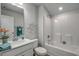 Bright bathroom with a white vanity, decorative mirror, and shower-tub combination at 312 Mayflower Dr., Calabash, NC 28467