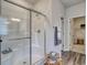 Bright bathroom featuring a stand-up shower with glass doors and neutral grey walls at 312 Mayflower Dr., Calabash, NC 28467