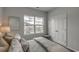 Well-lit bedroom featuring a double closet, cozy bedding, and a window view at 312 Mayflower Dr., Calabash, NC 28467