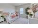 Cozy bedroom featuring a daybed with pink accents, complemented by a large plant and dresser at 312 Mayflower Dr., Calabash, NC 28467
