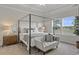 This bedroom features a canopy bed, natural light and neutral decor at 312 Mayflower Dr., Calabash, NC 28467