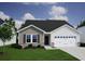 Charming single-story home with stone accents, a two-car garage, and a well-maintained lawn at 312 Mayflower Dr., Calabash, NC 28467