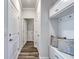 Bright hallway with wood floors and a built-in storage bench with hooks at 312 Mayflower Dr., Calabash, NC 28467