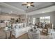 Spacious living room featuring a comfortable white sofa, tray ceiling, and seamless flow into the kitchen at 312 Mayflower Dr., Calabash, NC 28467