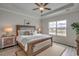 Comfortable main bedroom with a large window, a wooden bed frame, and soft, neutral decor at 312 Mayflower Dr., Calabash, NC 28467