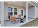 Cozy outdoor porch setting with wicker furniture and a modern coffee table at 312 Mayflower Dr., Calabash, NC 28467