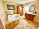 Bathroom featuring a jacuzzi, large counterspace, and a beige tile finish at 3302 Highway 905, Conway, SC 29526