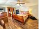 Comfortable bedroom with hardwood floors, queen bed, rustic furniture, and personal touches at 3302 Highway 905, Conway, SC 29526