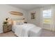 Serene bedroom with lake views, a surfboard, and surf-themed decor at 356 Rookroost Circle, Conway, SC 29526