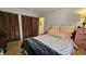 This bedroom features a large bed, two closets and tile flooring at 3700 Golf Colony Lane # 10C, Little River, SC 29566
