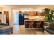 Cozy kitchen featuring stainless appliances, dark cabinetry, breakfast bar, and an adjoining living space at 3700 Golf Colony Lane # 10C, Little River, SC 29566