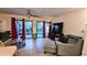 Inviting living room with sliding glass doors, patio access, ample seating and a ceiling fan at 3700 Golf Colony Lane # 10C, Little River, SC 29566