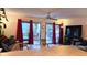 Inviting living room with sliding glass doors, patio access, ample seating and a ceiling fan at 3700 Golf Colony Lane # 10C, Little River, SC 29566