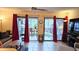 Inviting living room with sliding glass doors, patio access, ample seating and a ceiling fan at 3700 Golf Colony Lane # 10C, Little River, SC 29566