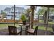 Cozy screened-in patio with seating and view of community pool at 3700 Golf Colony Lane # 10C, Little River, SC 29566