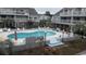 Community pool with chairs and palm trees for shade at 3700 Golf Colony Lane # 10C, Little River, SC 29566