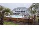 Relaxing pool area with palm trees, outdoor seating, and multi-story condominiums in the background at 3700 Golf Colony Lane # 10C, Little River, SC 29566