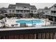 Community pool with chairs and palm trees for shade at 3700 Golf Colony Lane # 10C, Little River, SC 29566