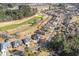 An aerial shot shows a home located on a golf course, surrounded by lush trees and other beautiful homes at 387 Foxtail Dr., Longs, SC 29568