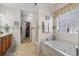 Bright bathroom featuring walk-in shower, soaking tub, double sink vanity and walk-in closet at 387 Foxtail Dr., Longs, SC 29568