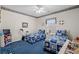 Nautical themed bedroom with two beds, ceiling fan and patterned blue carpet at 387 Foxtail Dr., Longs, SC 29568