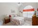 Inviting bedroom with a large window allowing natural light and a floral design bed at 387 Foxtail Dr., Longs, SC 29568