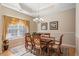 An elegant dining room boasts wood furniture, a chandelier, and an elevated ceiling at 387 Foxtail Dr., Longs, SC 29568