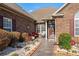 Charming front entrance featuring red chairs and nicely landscaped at 387 Foxtail Dr., Longs, SC 29568