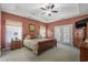 A main bedroom offers a ceiling fan, carpet flooring, and a large wood bed at 387 Foxtail Dr., Longs, SC 29568