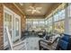 Bright sunroom boasts brick walls, a ceiling fan, and large windows at 387 Foxtail Dr., Longs, SC 29568