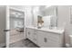 Spacious bathroom with double vanity, sleek quartz countertops, and an open view to the light-filled bedroom at 395 S Crow Creek Dr. # 1704, Calabash, NC 28467