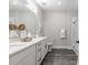 Elegant bathroom with dual sinks, modern fixtures, quartz countertops, and a sleek glass-enclosed shower at 395 S Crow Creek Dr. # 1704, Calabash, NC 28467
