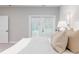 Bright bedroom with a view to the outdoors through French doors with blinds, inviting natural light at 395 S Crow Creek Dr. # 1704, Calabash, NC 28467