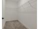 Empty walk-in closet with white wire shelving, and carpet, awaiting personalized organization at 395 S Crow Creek Dr. # 1704, Calabash, NC 28467