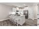 Modern kitchen with white cabinets, stainless steel appliances and a large kitchen island at 395 S Crow Creek Dr. # 1704, Calabash, NC 28467