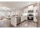 Modern kitchen with white cabinetry, stainless steel appliances, and an island at 395 S Crow Creek Dr. # 1704, Calabash, NC 28467
