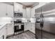 Kitchen featuring stainless steel appliances, sleek white countertops, and white cabinetry at 395 S Crow Creek Dr. # 1704, Calabash, NC 28467